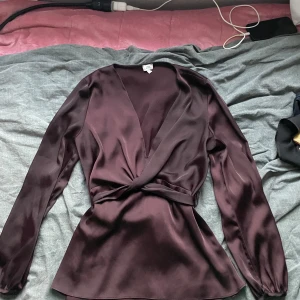 Vinröd blus  - Vinröd blus som har silke material. 