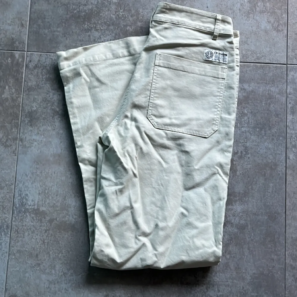 Fina ljusa byxor i låg, vid modell, Maude,  från Deus Ex Machina. Byxorna är i nyskick. https://deuscustoms.eu/products/maude-pant-dirty-white. Jeans & Byxor.