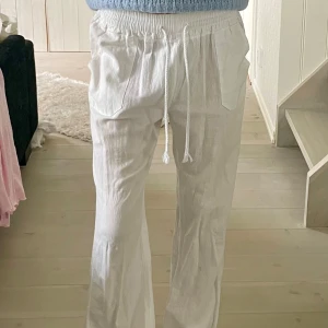 Linnebyxor - Vita linnebyxor med ett detaljhjärta på bakre fickan. Passar XS och S