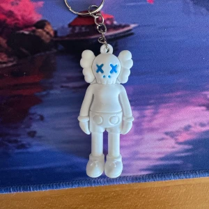 White/blue kaws figure - It’s like 6.3 cm tall and made out of some hard rubber.