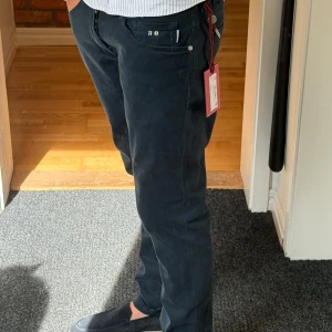 Nya mörkblå chinos från Tramarossa - Säljer ett par mörkblå chinos från Tramarossa med slim/rak passform och snygga detaljer. Passar bra på mig, så rekommenderar till personer som är ca 180-190 långa. Dessa var en present och då jag redan har flera mörkblå byxor och returtiden har gått ut måste jag sälja. Nypris var 3499kr. Förövrigt helt nya endast testade.