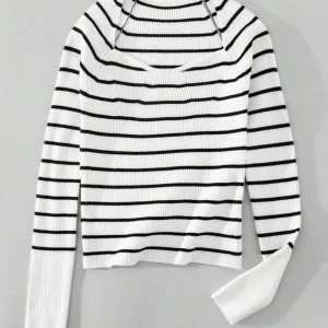 Vit och svart randig ribbad tröja - Säljer en vit ribbad tröja med svarta horisontella ränder och långärmad design. Tröjan har en unik fyrkantig halsringning som ger en cool och modern vibe. Materialet är stretchigt och sitter snyggt på kroppen, perfekt för dig som gillar stilrena och trendiga plagg.
