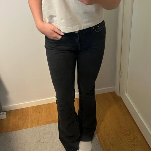 Svarta bootcut jeans - Snygga svarta jeans från Gina Tricot med bootcut-modell. Jeansen har en mörk tvätt och sitter tajt upptill med utsvängda ben. Något urtvättade men annars sparsamt använda💕