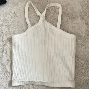 Vit ribbad linnetopp från Gina Tricot - Säljer en vit ribbad linnetopp från Gina Tricot i storlek XS. Säljer den då de inte kommer till användning.