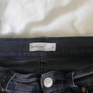 Svarta jeans från Perfect Jeans - Säljer ett par svarta jeans från Perfect Jeans i storlek 34. Jeansen har klassisk femficksdesign, har sprättat upp sömmen längst ner för att de ska passa i längden för mig som är 163 cm💗