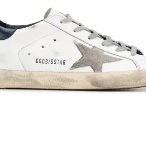 Vita sneakers med grå stjärndetalj från Golden Goose - Säljer ett par vita sneakers från Golden Goose med grå stjärna på sidan och grå snörning. Skorna har en beige, något smutsad sula och svart detalj vid hälen. Perfekta för en avslappnad och trendig stil.