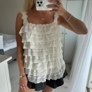 Vit volangig spetslinne - Säljer ett vitt linne med flera lager volanger och spetsdetaljer. Från Rosemunde i storlek L (jag brukar bära S)🤍🤍🤍🤍