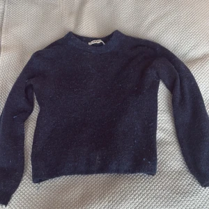 Mörkblå stickad tröja från Soft Rebels - Mysig mörkblå stickad tröja från Soft Rebels i storlek XS. Tröjan har rund halsringning och långa ärmar, perfekt för kyligare dagar. Enkel och stilren design som passar till mycket. Har ett hål under hals kragen