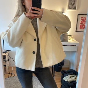 Beige kappa med knappar - Fin kappa till våren⭐️, den är väl använd så har sina fläckar men det går nog bort direkt i tvätten! Annars väldigt fint skick