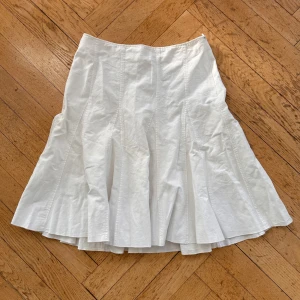 Sommarkjol - Vit sommarkjol från Russo Conti. Inte alls genomskinlig. Perfekt för sommaren. Gjord av linne och bomull. Midja 37 cm tvärs över. Längd 60 cm.