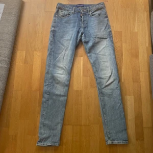 Ljusblå jeans från Scotch & Soda - Storlek W30 och L34! Snygga ljusblå jeans från Scotch & Soda med klassisk femficksdesign och subtila slitningar. Jeansen har raka ben och normal passform, tillverkade i mjukt bomullsjeansmaterial. Perfekta för en avslappnad och trendig look.