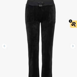 Svarta Juicy Couture  - Svarta mjukisbyxor från Juicy Couture i mjuk velour med bred resår och snörning i midjan. Byxorna har raka ben, fickor fram och bakfickor med knapp. Perfekta för en chill och trendig look. (Två bilder från nätet)