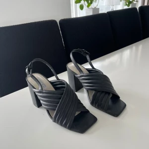 Damskor - Säljer dessa nya klackskor då de ej är till användning. Skorna är svarta och riktigt fina med en unik design. Perfekt för varma dagar. Skorna är i princip nya och säljs billigt, så först till kvarn!