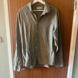 Ljus grön skjorta från Solid - Säljer en stilren ljus grön skjorta från Solid med regular fit. Skjortan har långa ärmar och knäppning framtill. Perfekt för dig som gillar en enkel och clean look.