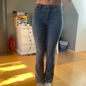 Blå bootcut jeans - Säljer ett par klassiska blå bootcut jeans med hög midja. 