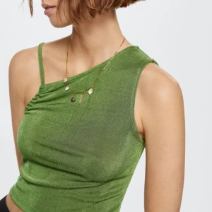 Grön oneshoulder topp  - Snygg grön oneshoulder topp med smalt axwlband. Tunt, mjukt material som faller fint och ger en avslappnad vibe. Från mango💚 Står storlek XL men den sitter som en S enligt mig. 