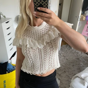Vit stickad blus med volang från Zara - Superfin vit stickad blus från Zara med kort ärm och bred volangdetalj över axlarna. Bra skick då den inte har kommit till användning! 💕perfekt topp att ha nu till sommaren.