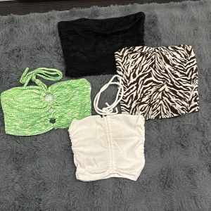  bandeau toppar i olika färger och mönster - Säljer fyra bandeau toppar: en svart spetsig, en vit ribbad från Zara, en grön mönstrad med knyt från Pelin x Koton och en brun/vit zebramönstrad från Ambar. Perfekta för sommaren och festivaler, mixa och matcha med dina favoritjeans eller kjol. Pris varierar beroende på vilken du vill ha 
