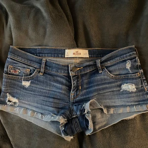 Skitsnygga low waist shorts! - Snygga blå jeansshorts från Hollister som är ultra lågmidjade. Midjemåttet är 39 cm rakt över och längden är 18 cm neråt. Säljer då de tyvärr är pyttelite för små!💞Kom privat för bilder på!