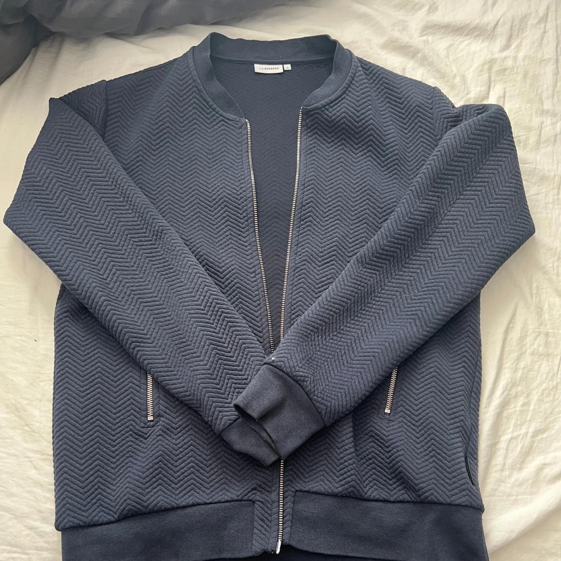 Mörkblå zip up tröja från J.Lindeberg