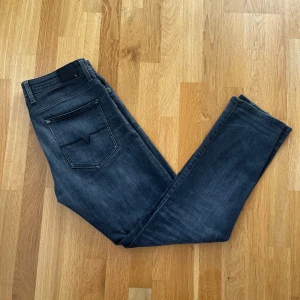 Mörkblå jeans från Bison - Snygga mörkblå jeans från Bison med en klassisk femficksdesign. De har en tapered åt det mer slimmade passform och är tillverkade i ett stretchigt material för extra komfort. Perfekta för en stilren look. Endast använda en gång! Köpta för 1300kr!