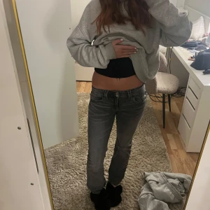 Grå bootcut jeans från Gina Tricot - Snygga grå jeans från Gina Tricot med låg midja och dragkedja. Perfekta för en avslappnad stil. De har en klassisk femficksdesign och en bekväm passform. Säljer då de blivit för små för mig !💞💞