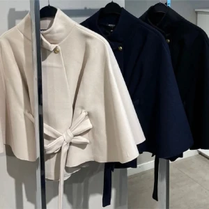 SÖKER beige Missäy poncho - Elegant beige kappa från Massimo Dutti med knytband i midjan och dekorativa knappar vid halsen. Perfekt för en stilren look.