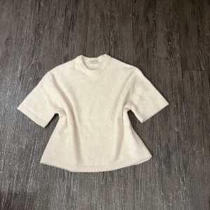 Vit stickad tröja från Gina Tricot - Säljer en stilren vit stickad tröja från Gina Tricot i premiumkvalitet. Tröjan har en rund hals och trekvartsärmar med ribbade kanter. helt ny utan prislapp, säljer då den inte är i min stil💞köpte för 300kr