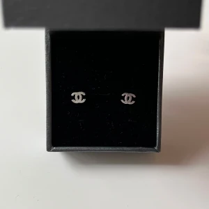 Silver örhängen  - Snygga små örhängen i äkta silver som är i helt nytt skick, örhängen har den ikoniska CC-loggan. Perfekta som diskret statement och passar till allt. 