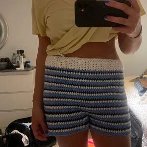Virkade shorts i blått och vitt - Virkade shorts med randigt mönster i vitt, ljusblått och marinblått.  Mjuka och sköna, med loose fit och hög midja. Töjbara så skulle säga att de passar S & M storlek