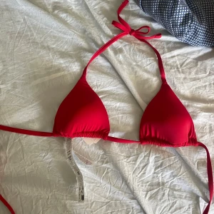 Röd trekantsbikini från Calzedonia - Snygg röd trekantsbikini från Calzedonia i färgen chili red. Klassisk modell med knyt i nacken och ryggen. Aldrig använd och har prislappen kvar🥰