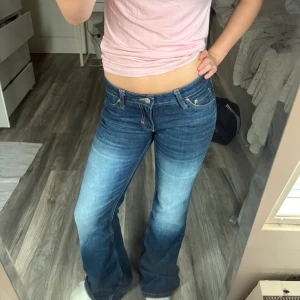 Nova bootcut jeans från weekday  - Snygga blå jeans från weekday med bootcut passform och klassisk femficksdesign utan något slitage. Jeansen har låg midja och är tillverkade i slitstarkt denim. storlek 27/32 