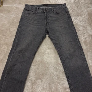 Grå relaxed jeans Jack & Jones - Säljer ett par grå jeans från Jack & Jones i relaxed fit, modell Chris. Jeansen har klassisk femficksdesign, raka ben och normal midja. Tillverkade i mjukt denimtyg som ger en avslappnad vibe. Jeansen är sparsamt använda och skicket är 9,5/10 dem har inga skador och är i storleken 32/30. Hör av vid frågor 