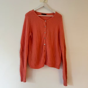 Korallrosa kofta med knappar - Stickad kofta med knappar