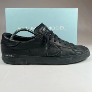 Philippe Model - Snygga svarta sneakers från Philippe Model i skinn. Skorna har en stilren design med snörning och diskreta detaljer. Perfekta för en casual look med en touch av elegans.