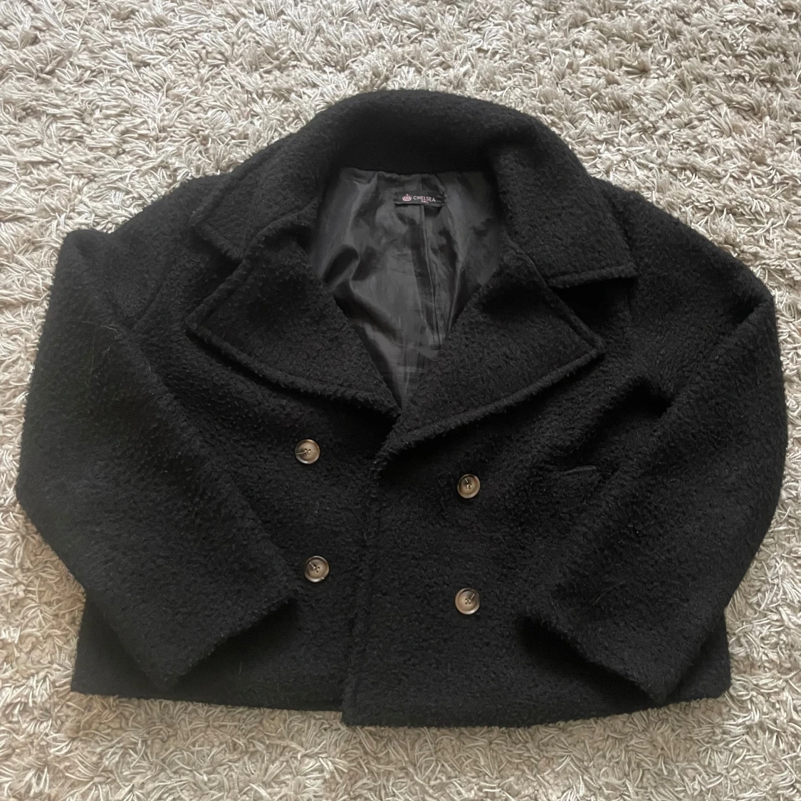 Svart teddykappa från Chelsea 