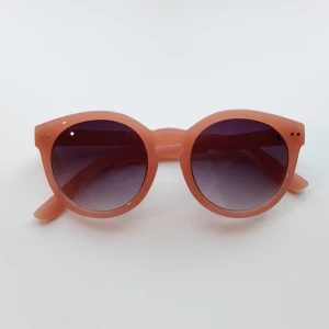 Rosa solglasögon - Snygga runda solglasögon med rosa båge och mörka linser. Är ganska små i storlek och ena skalmen (alltså "armen") på glasögonen är något mer böjd än den andra, men det går nog att justera. Pris kan alltid diskuteras.