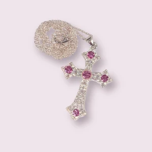 Y2K kors halsband  - Säljer ett kors halsband! Riktigt fett och i bra skick. För dig som letar efter ett unikt kors halsband. En rosa Sten har dock lossnat, annars i bra skick! 