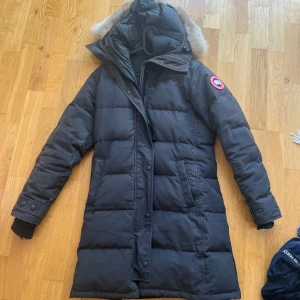 Canada goose jacka  - En Canada Goose vinter jacka. Den är välanvänd och har några defekter (se bild 4-5). Den är jätte varm och går ner till låren ungefär. Pälsen på luvan går att ta bort.