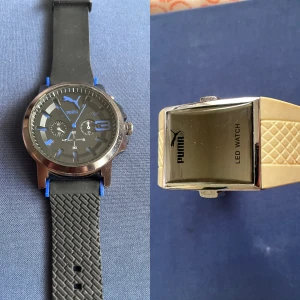 Två Puma klockor, svart och gul - Säljer två snygga Puma klockor! En har svart och blå urtavla med sportig look som behöver batteri,rund boett i silver och svart mönstrat gummiband. Den andra är en LED-klocka med gul gummirem och rektangulär boett i silver och fungerar inte alls. Båda har coola detaljer och passar dig som gillar streetstyle.