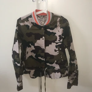 Baum und Pferdgarten  - Tunn jacka perfekt nu till våren som är helt i oanvänt skick. I snyggt militärmönster. Prislappen sitter kvar, nypriset var 1999kr. Stängs med knappar. Fickor finns på sidorna. Snörning nertill så att man kan anpassa passformen. Skitsnygg!!!