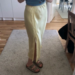 Jättefin kjol i silke med slits. - Gul kjol i silke med en superfin slits. Perfekt till sommaren. Säljer då den tyvärr inte kommer till användning. Köpare står för frakt.