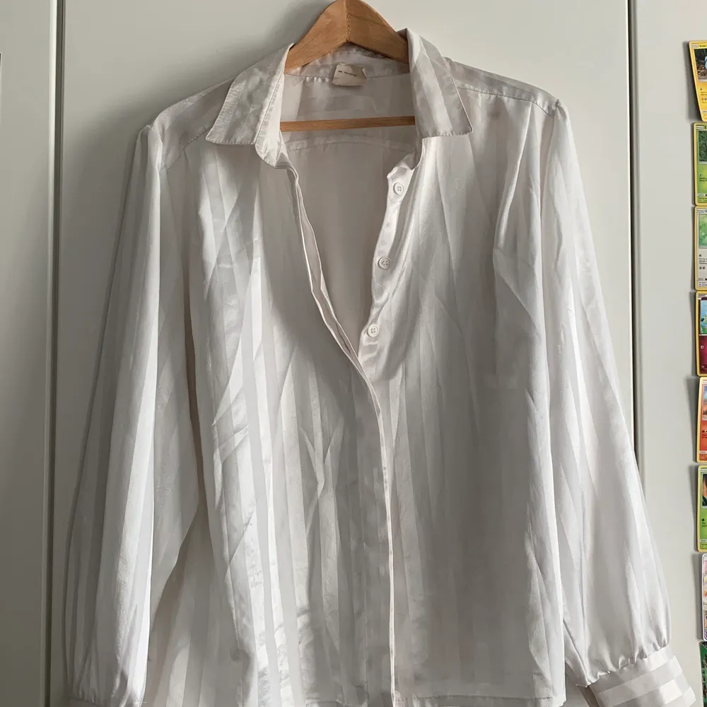 Skjortan säljs för att den helt enkelt inte används längre, den är vit men randig i ett siden aktigt material. Den är väldigt skön och luftig, helt enkelt väldigt bekväm att ha på sig. Det står inte storlek på den men kan gissa på att det är storlek M/L för det är typ det jag bär.. Blusar.