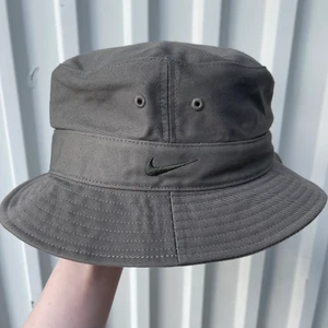 Nike buckethat  - Fiskehatt från Nike, ca 20 cm i diameter. Färgen är typ mörkgrå/grön.