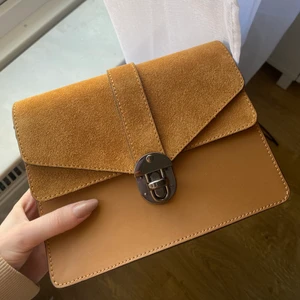 Liten väska - Helt ny superfin liten väska i äkta läder och mocka💞 köpt i en liten läderbutik i Venedig och helt oanvänd. Den är i otroligt bra och fin kvalitet, finns axelband till den också💕💕 Köpte för 1300 säljer för 400