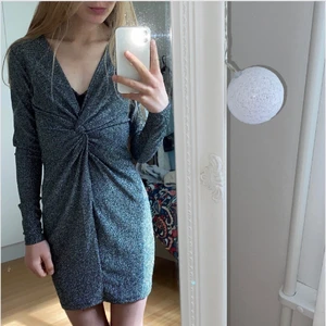 Glittrig Klänning  - En silver glittrig klänning köpt från Hm.                                                                               Mycket bra sick. Använd 2-3 gånger.                                                 Frakt ingår inte i priset.