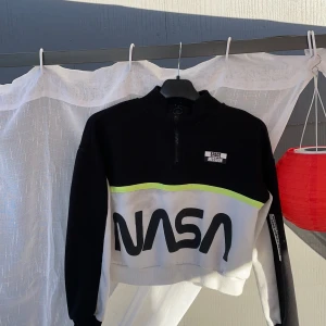 H&M nasa tjocktröja  - En svart, vit och neon grön/gul nasa tjocktröja från H&M. Med en svart Dragkedja.
