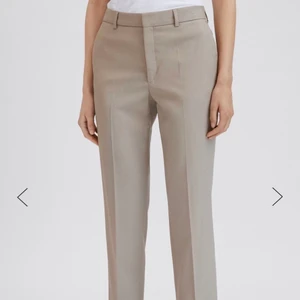 Filippa K kostymbyxor storlek 38 - Superfina och helt oanvända kostymbyxor från Filippa K i modellen Emma Cropped Cool Wool Trouser och färgen Dessert Taupe I storlek 38, nypris 1700 kr prislapp finns kvar. Frakt ingår!