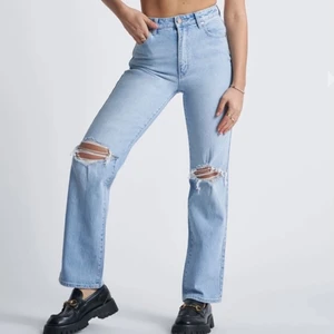 Abrand jeans strl W24 - Blåa vida jeans från Abrand Jeans med slitningar på knäna. Endast använda en gång. Säljer p.ga. inte kommit till användning. Det är strl W24 och det passar mig bra som är 163cm. Originalpris: 999kr. Frakten ingår inte i priset.