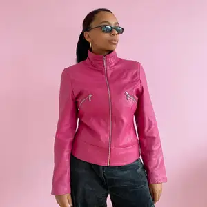 Leather jacket in pink/fuchsia with two breast pockets. In good condition 